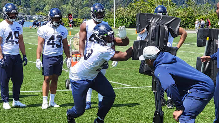 Seahawks linebacker Boye Mafe works his hand technique against a blocking sled during organized team activities.
